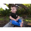 cute baby boy sitting down in a wooden bench while wearing a round neck tshirt template a16088