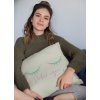mockup of a woman holding a square pillow while sitting 23577 2