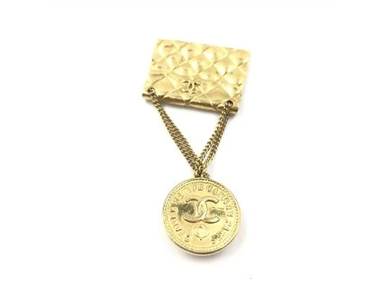 Brož s motivem zlaté pokovené tašky