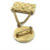 Brož s motivem zlaté pokovené tašky
