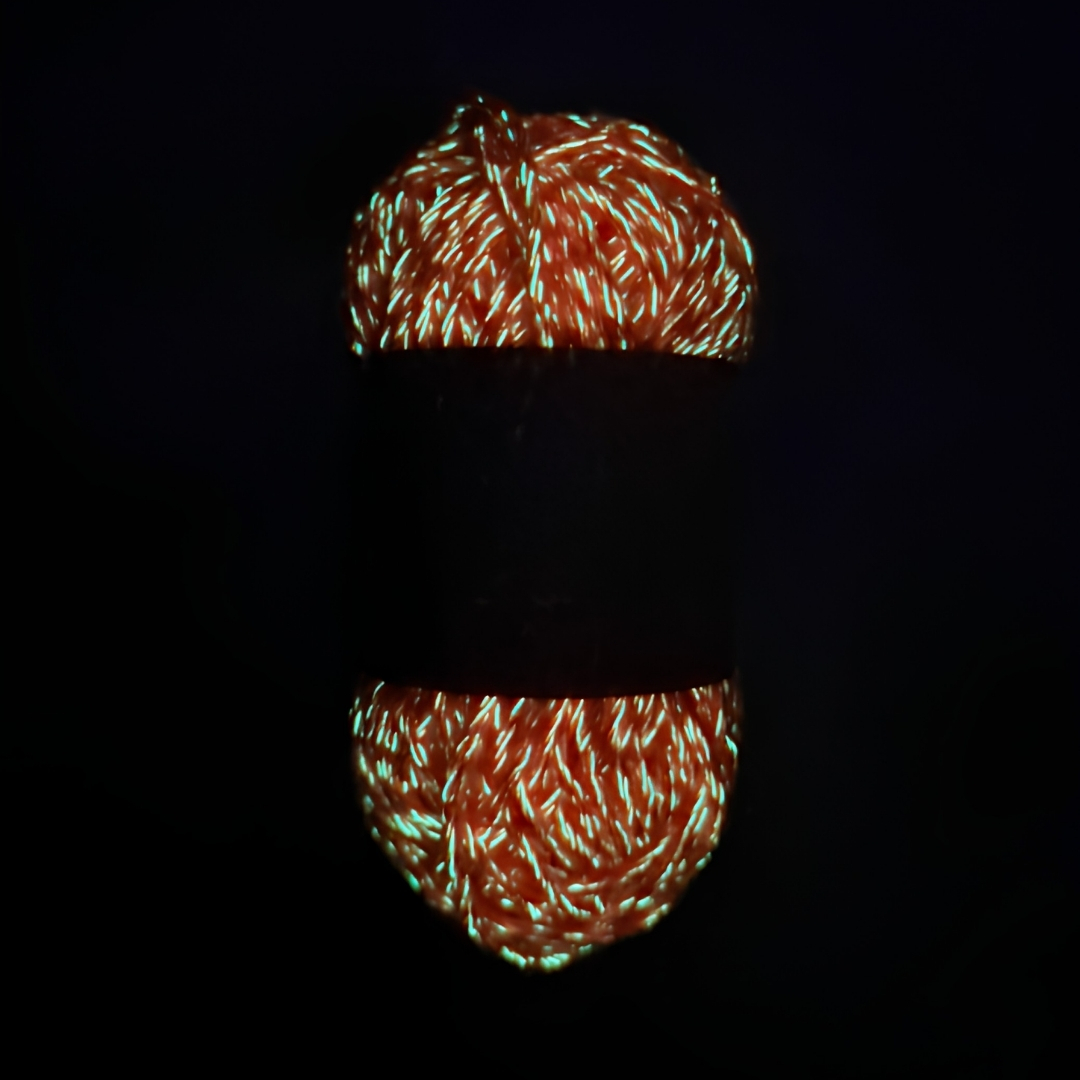 Orange glow in the dark yarn with a soft green glow