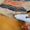 appliing glue gun to rug