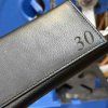 Černá kožená kasírka BELLUGIO Leather s monogramem (ražba)  + Akce - zlatá mince Pro štěstí ZDARMA
