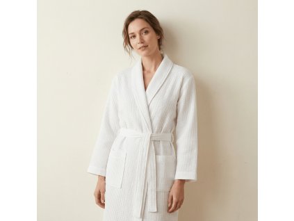 woman wearing white waffle bathrobe, wjth the background of creamy wall @White waffle bathrobe