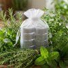 Generated with Kive.ai place this product placed on the table surrounded with lots of garden herbs resized