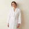 woman wearing white waffle bathrobe, wjth the background of creamy wall @White waffle bathrobe