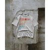 boxy tshirt mockup hanging on textured concrete wall industrial style natural light apparel template 01088