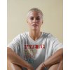 minimal t shirt mockup female model in relaxed white tee sitting against soft beige wall casual and confident look 01229