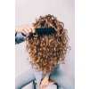 woman combing curly hair getty 1119 2000 e7ba798763064403a38d9b66d5169b49