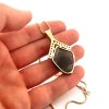 Moldavite pendant in gold with garnet 2000276160000
