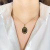 Moldavite pendant in gold with garnet 2000103690007