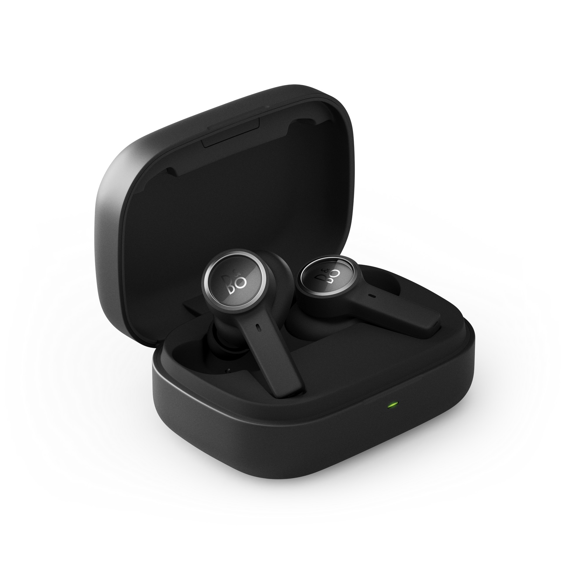 Otevřené nabíjecí pouzdro Beoplay EX se sluchátky vystupujícími z lůžek a zelenou nabíjecí kontrolkou
