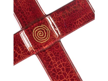 Krzyż szklany rubinowy ze złotą spiralą na białej ścianie