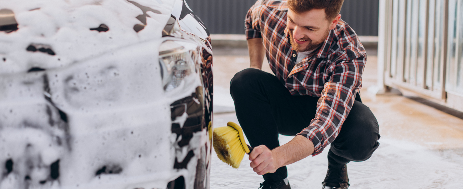 young-man-washing-his-car-carwash