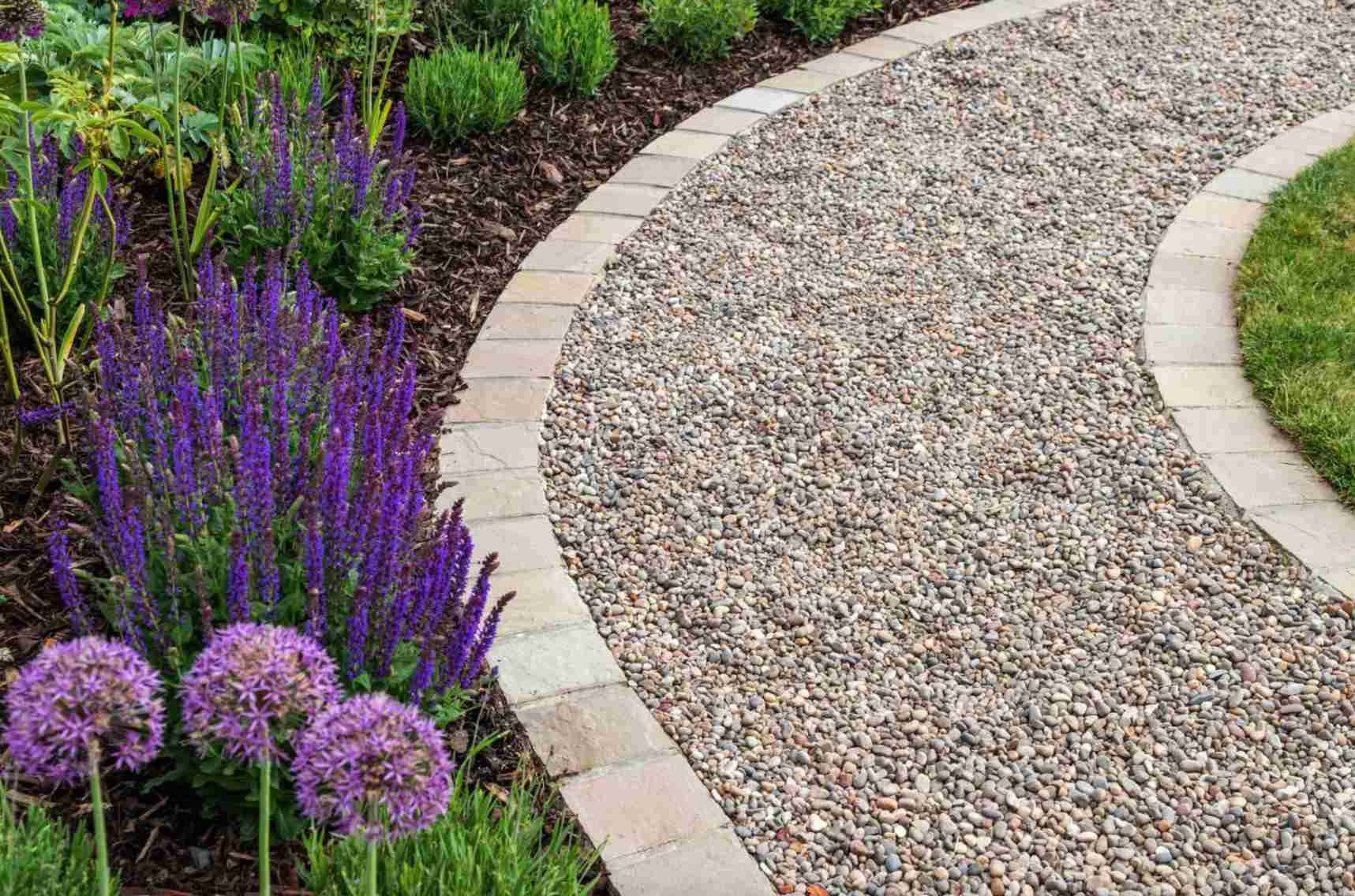 strkovy-chodnik-z-jemneho-okrashneho-strku-lemovany-svetlymi-kamennymi-obrubnikmi-a-obklopeny-kvitnucimi-zahonmi