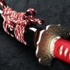 Řemeslná replika katany se skládanou čepelí, červeným opletem rukojeťi a černou lesklou pochvou se třpytem. p