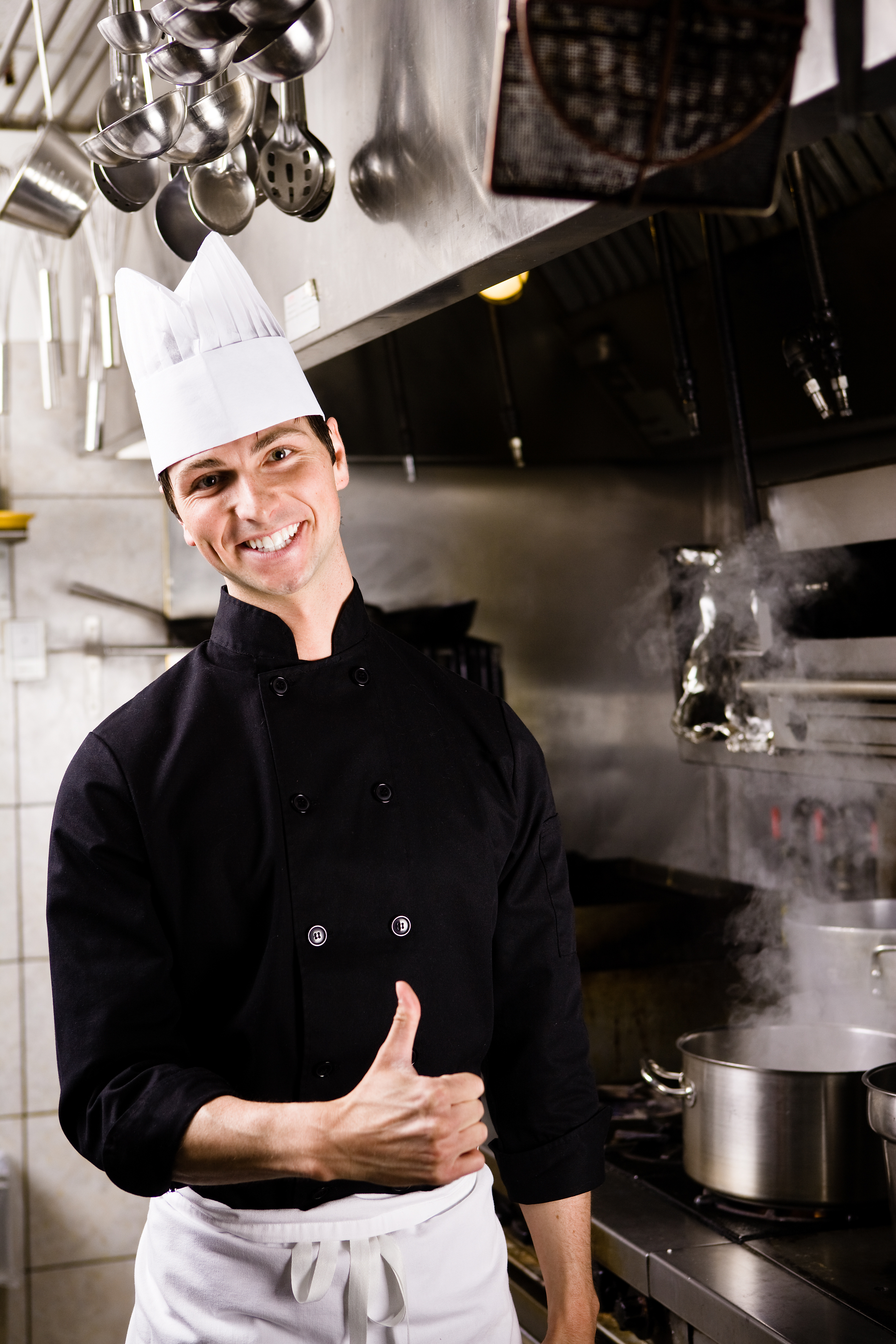 smiling-chef-posing-in-restaurant-kitchen-2429009
