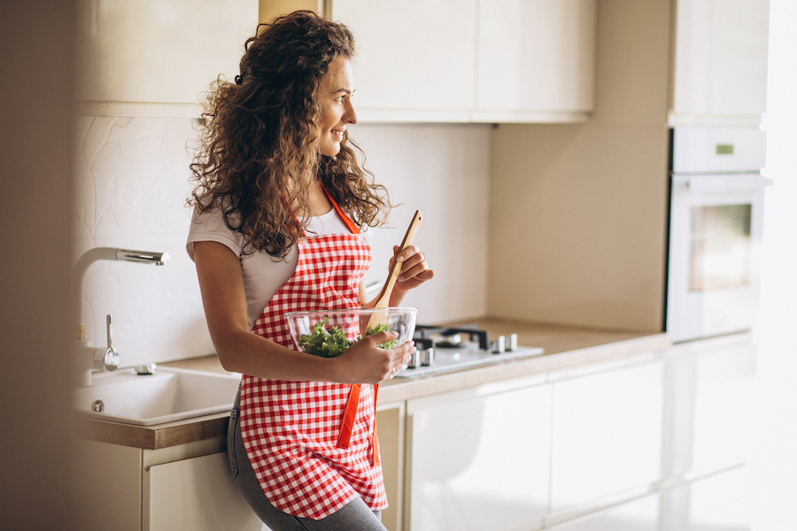 woman-chef-making-salad-kitchen